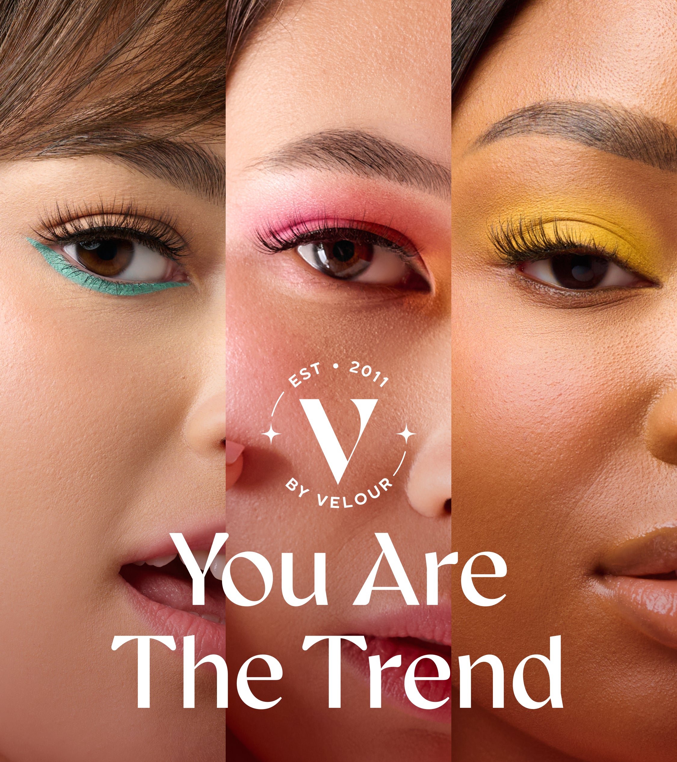 Banner features a close-up of three diverse models' eyes, each showcasing bold, colorful eye makeup and long, voluminous lashes. The left model has teal eyeliner, the middle model wears pink and red eyeshadow, and the right model has yellow eyeshadow, all enhancing their natural beauty. Centered in the image is the V by Velour logo, with the text "You Are The Trend" displayed prominently in elegant, modern typography. The image embodies inclusivity, beauty, and self-expression.