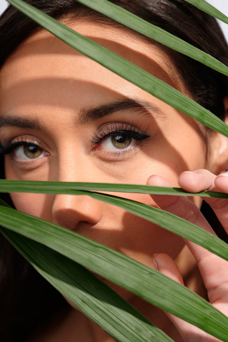 Model wearing plant based fiber eyelashes with plants