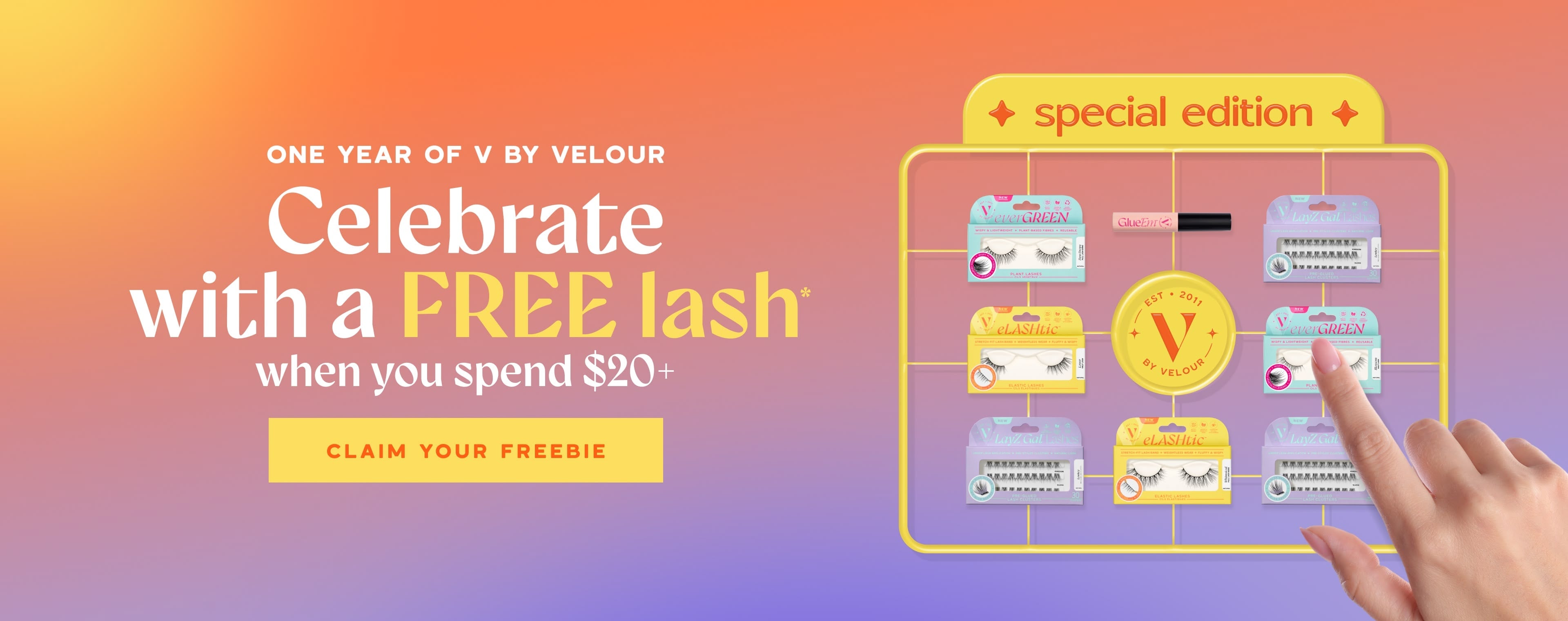 Celebrate one year of V by Velour. Our gift to you: a free lash with orders $20+. Special edition V by Velour lash collection display featuring EverGreen, eLashtic, LayZ Gal, and Glue’Em lashes on a gradient background. Button text states claim your freebie
