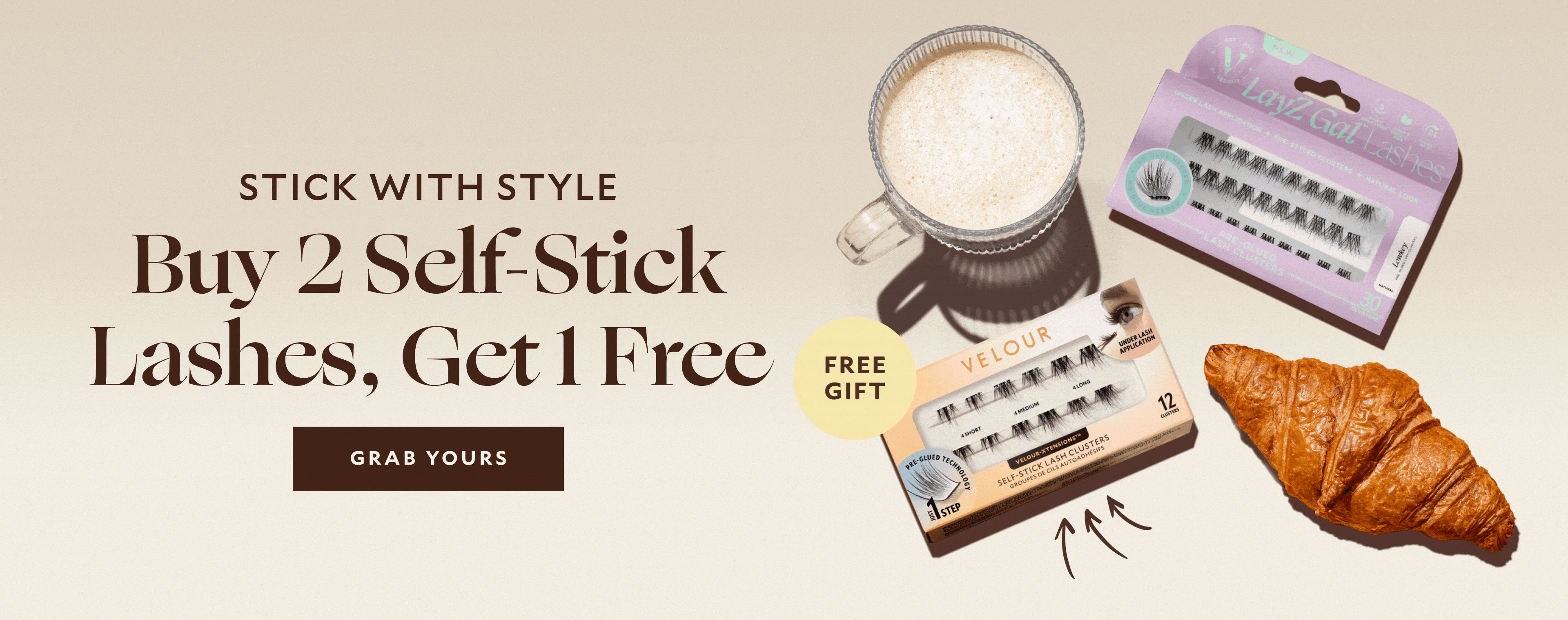 Stick With Style — Buy 2 Self-Stick Lashes, Get 1 Free. CTA button: Grab Yours. Velour Free Gift Self-Stick Lash Clusters and Lazy Gal Lashes displayed with coffee and croissant.