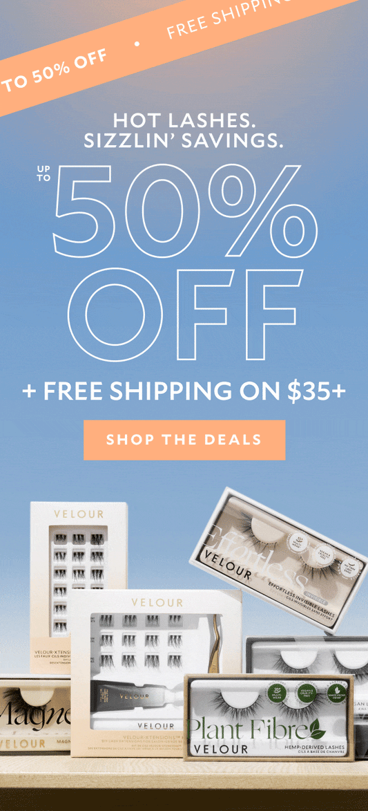 Model applying lashes with gold applicator. Text reads: 'HOT LASHES. SIZZLIN’ SAVINGS. UP TO 50% OFF + FREE SHIPPING ON $35+.' Diagonal banner at top says 'FREE SHIPPING • UP TO 50% OFF.' Button text: 'SHOP THE DEALS.' Gradient blue to peach background.